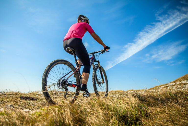 Female mountain biker on Nanos plateau in Slovenia on a sunny day